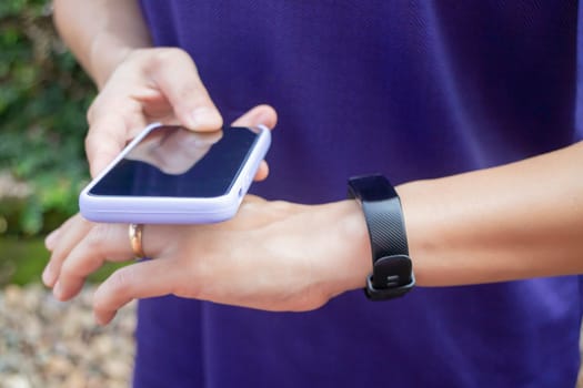 Healthy lifestyle concept female wearing sport tracker wristband arm, stock photo