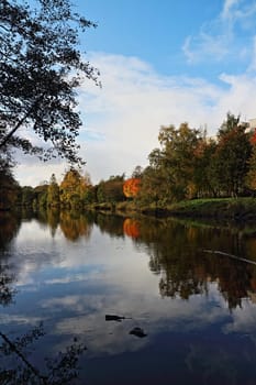 the sky is reflected in a beautiful autumn landscape