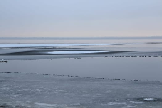 lake is covered with thin ice,  winter landscape