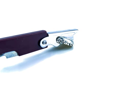 Beer bottle cap and bottle opener on a white background. Place for text.
