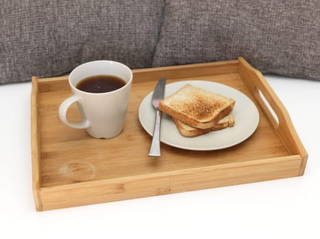 A close up shot of a wooden breakfast tray