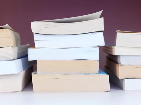 A close up shot of a pile of books