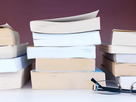 A close up shot of a pile of books