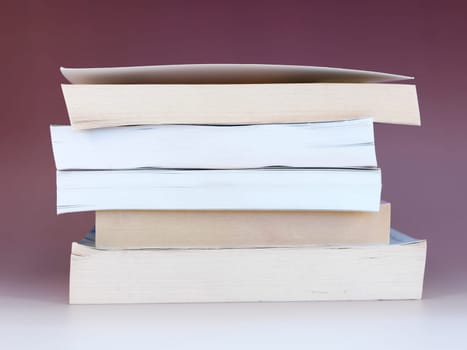 A close up shot of a pile of books