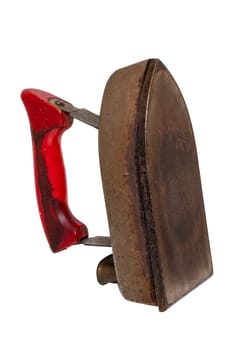 Old iron isolated. Close-up of a professional old rusty electric tailor iron or flatiron with a red handle isolated on a white background. Tailoring accessories 50's or 60'syears.