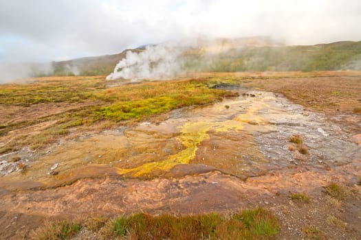 Steam and Colorful Bacteria at the Geysir Thermal Area in Iceland