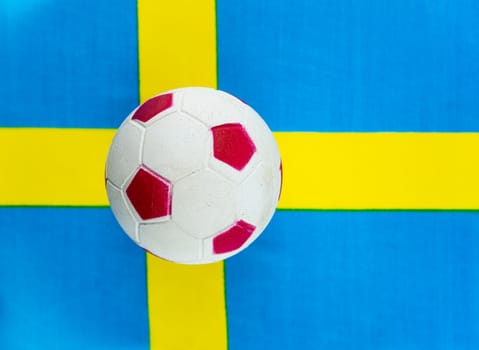 Soccer ball on the background of the national flag of Sweden. National Association. World Championship. Champions League. UEFA Europe championship.