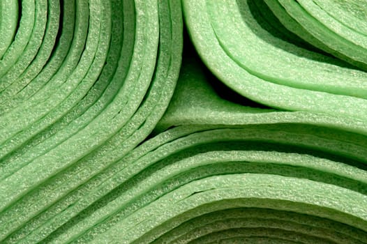 Close up of rolled up green foam material mats for construction purpose.