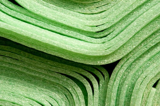 Close up of rolled up green foam material mats for construction purpose.