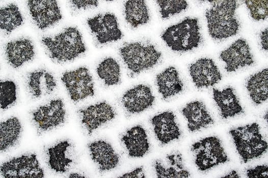 Snowfilled granite pavement gaps make a pattern on the ground