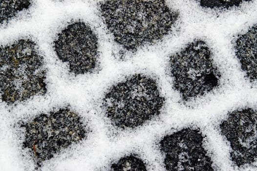 Snowfilled granite pavement gaps make a pattern on the ground