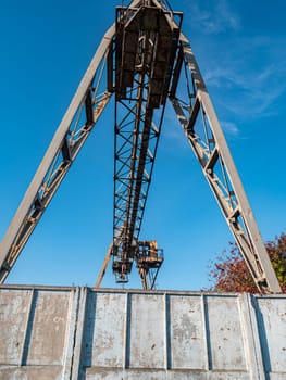 Industrial crane for carrying goods at the factory. Industrial landscape. Place for text.