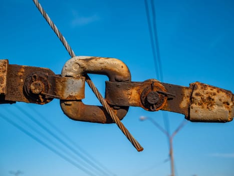 Coupling two metal cables. Industrial landscape. Place for text.