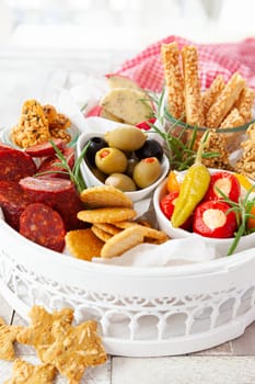 Colorful antipasti, cheese and savoury crackers for Christmas