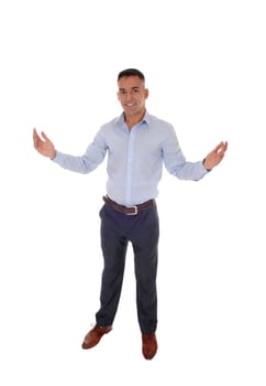 A handsome young east Indian man standing in a blue shirt with his.arms wide open, welcome everybody, isolated for white background.