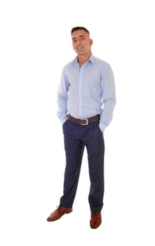 A handsome east Indian man standing in dress pants and a blue shirt.relaxed in the studio, smiling, isolated for white background.