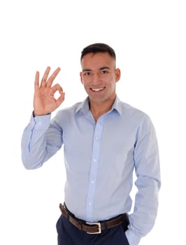 A young east Indian man standing in a blue shirt making an OK sign,.that he likes the idea, isolated for white background.
