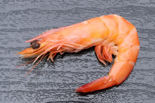 Close uo of red raw shrimps on a black background
