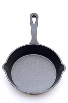 Empty small iron frying pan on a white background