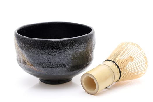 Tea bowl with tea whisk used in Japanese matcha green tea ceremony on white hackgrond