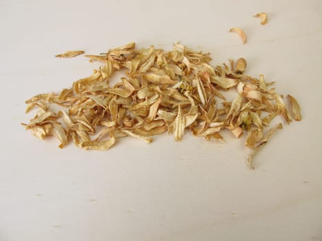 Dried orange blossoms of sweet orange on a wooden board