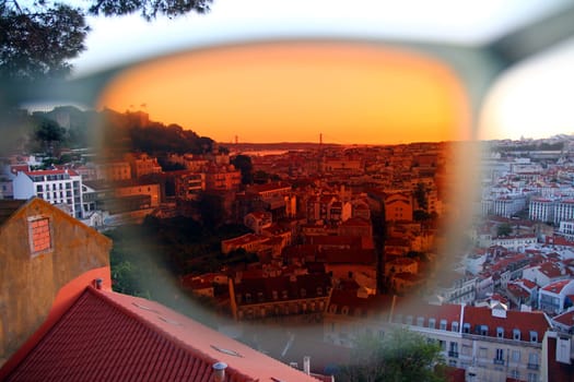 Lisbon panorama through a red lens of sunglasses