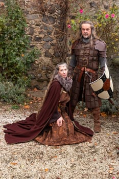Couple posing robed in beautiful medieval clothing
