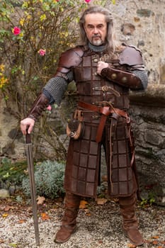Posing impressive Knight in historic medieval cloth