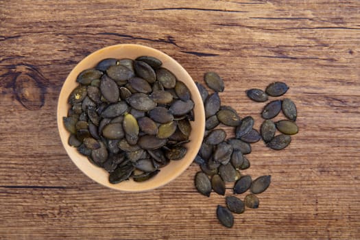 Pumpkin Seeds in a wooden Bowl in Detail