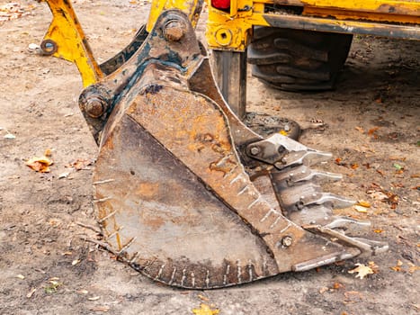 Iron bucket of a construction excavator. Technics.