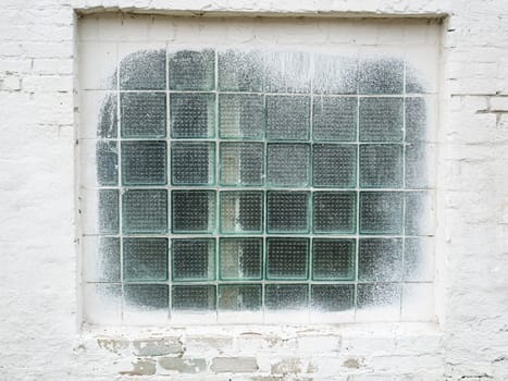 Window with a lattice in a white wall. Place for text. Background image.