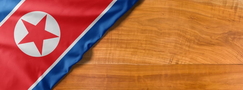 National flag of North Korea on a wooden background with copy space
