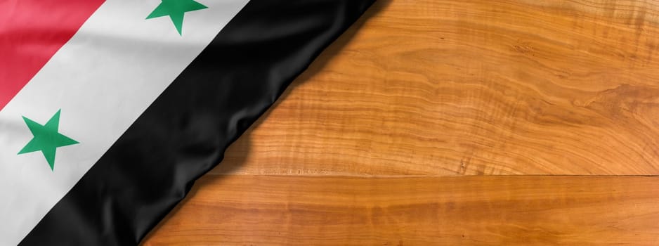 National flag of Syria on a wooden background with copy space