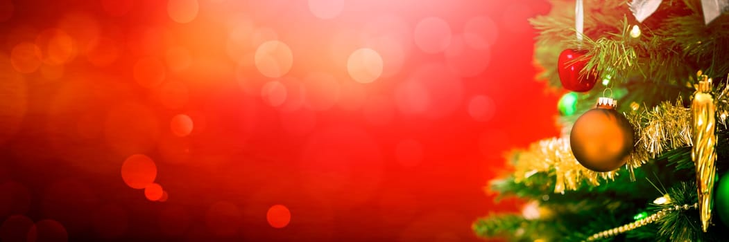 Decorated Christmas tree on red glowing background