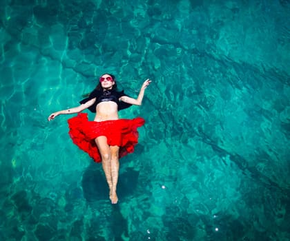 Aerial view of a beautiful woman dancing  in the sea