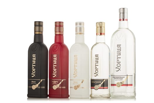 St.Petersburg, Russia - May 2019 - Set of several bottles of a kind of vodka Khortytsa on a white background with reflection.