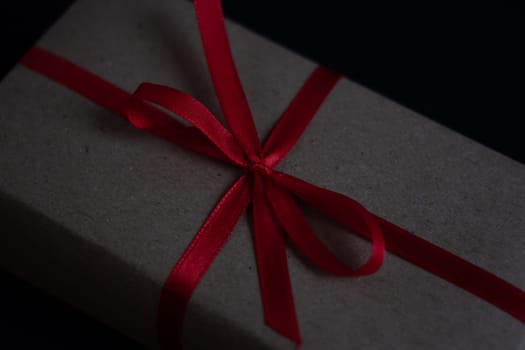craft gift box with bow knot on dark background