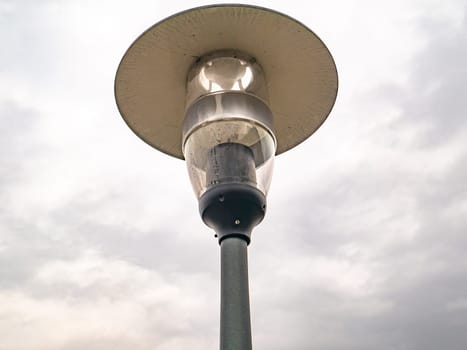 Street lamp lighting on a background of cloudy sky. Background. Place for text.