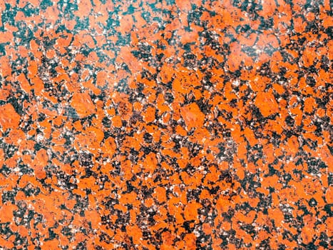 The texture of red granite into black dots. Background. Place for text.