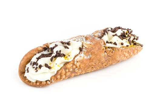 Sicilian cannolo stuffed with ricotta cheese cream, chocolate flakes and pistachio. Typical Sicilian dessert. Italian pastry.