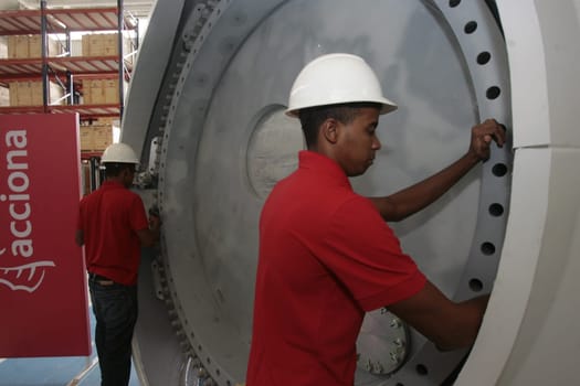 SIMOES FILHO, BAHIA / BRAZIL - May 13, 2015: Acciona Windpower wind turbine factory employees are seen working. (Joa Souza / Panthermedia).
