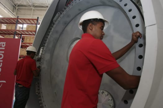 SIMOES FILHO, BAHIA / BRAZIL - May 13, 2015: Acciona Windpower wind turbine factory employees are seen working. (Joa Souza / Panthermedia).