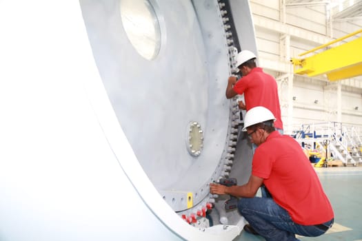 SIMOES FILHO, BAHIA / BRAZIL - May 13, 2015: Acciona Windpower wind turbine factory employees are seen working. (Joa Souza / Panthermedia).
