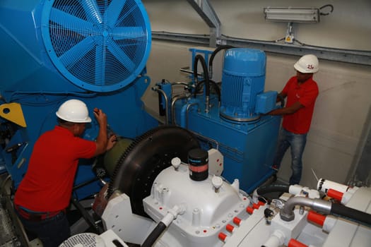 SIMOES FILHO, BAHIA / BRAZIL - May 13, 2015: Acciona Windpower wind turbine factory employees are seen working. (Joa Souza / Panthermedia).