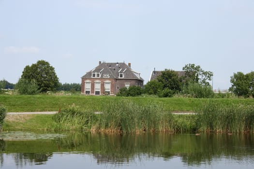 Lonely old House, with a body of water in the foreground