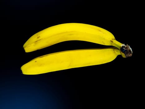 Yellow bananas on a black background. Place for text.