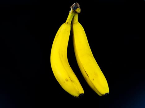 Yellow bananas on a black background. Place for text.