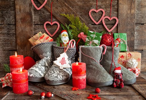 Knitted boots with little presents and candy for Christmas