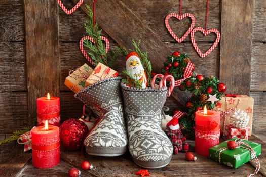 Knitted boots with little presents and candy for Christmas