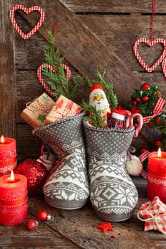 Knitted boots with little presents and candy for Christmas